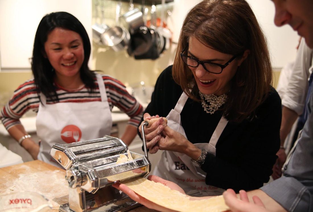 Guests rolling fresh pasta during a CookWithJames cooking class in San Francisco